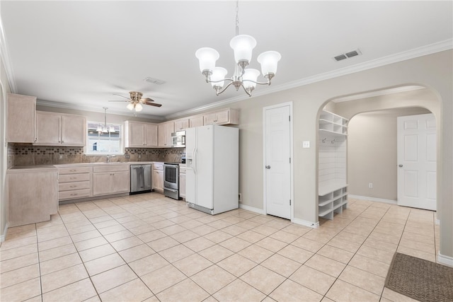 kitchen featuring appliances with stainless steel finishes, ornamental molding, light brown cabinets, tasteful backsplash, and light tile patterned floors