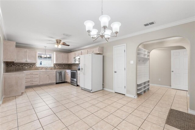 15522 Finistere St, Corpus Christi, TX 78418 - kitchen featuring stainless steel appliances, a chandelier, a ceiling fan, ornamental molding, and light countertops