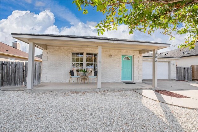 15522 Finistere St, Corpus Christi, TX 78418 - ranch-style home with brick siding, covered porch, driveway, and a garage