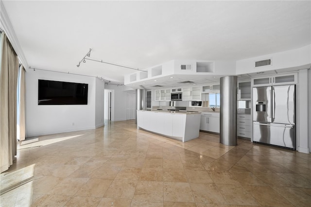 kitchen featuring white cabinetry and stainless steel built in fridge