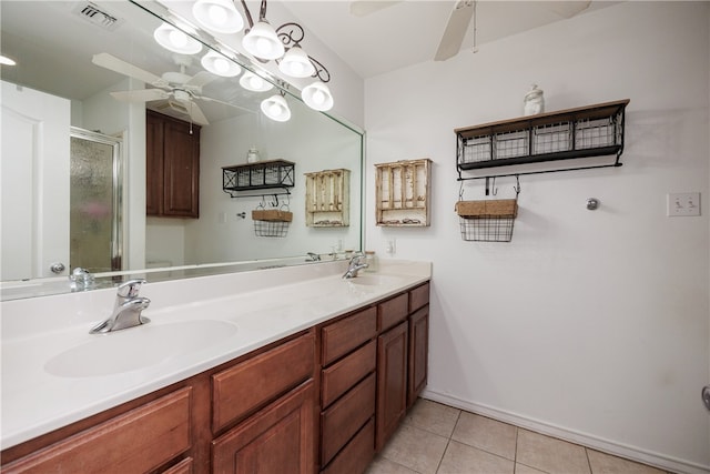 bathroom with tile patterned flooring, vanity, ceiling fan, and a shower with door