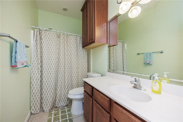 bathroom featuring toilet, vanity, and tile patterned floors