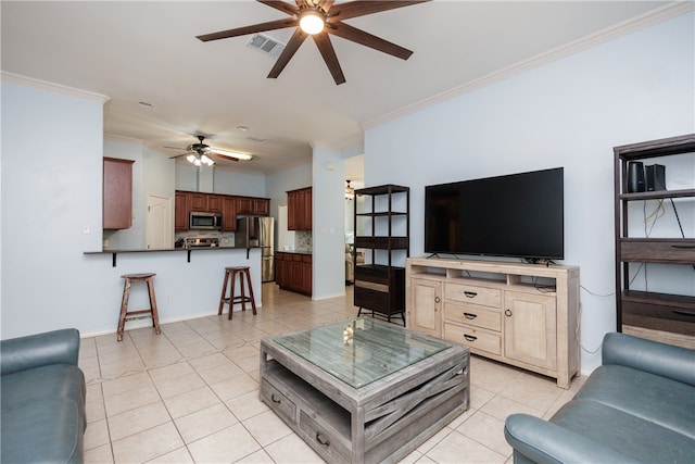 living room with ceiling fan, crown molding, and light tile patterned flooring