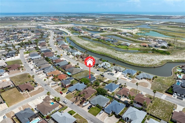 drone / aerial view with a water view and a residential view