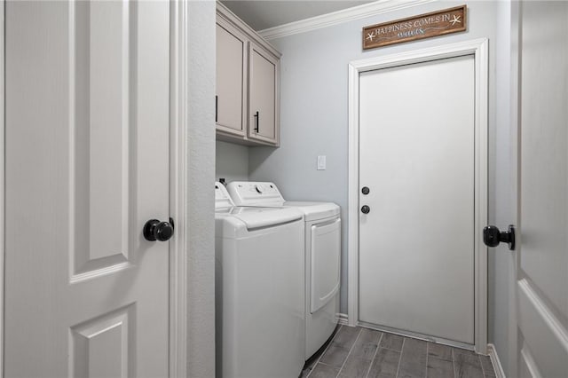 laundry area with cabinet space, washing machine and dryer, ornamental molding, and wood tiled floor