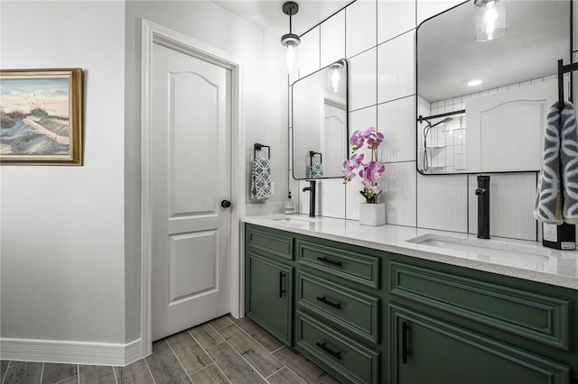 bathroom featuring a sink, baseboards, wood tiled floor, and double vanity