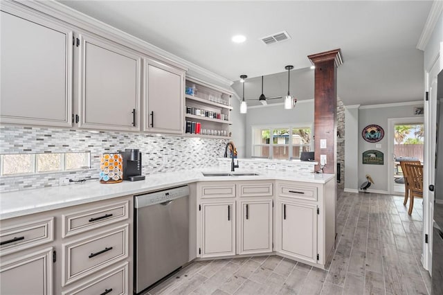 kitchen featuring a sink, dishwasher, light countertops, visible vents, and ornamental molding