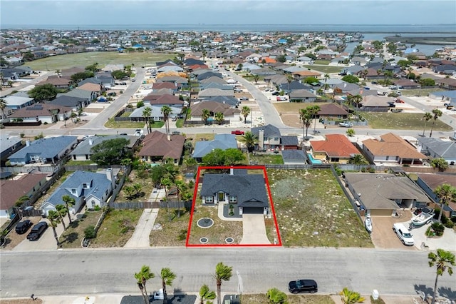 birds eye view of property with a water view and a residential view