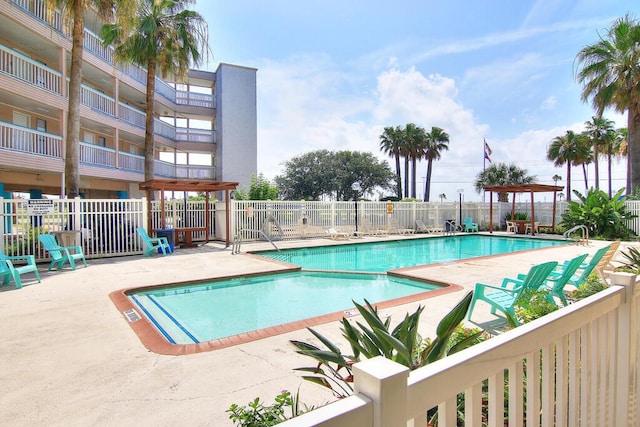 3938 Surfside Blvd Unit 2225, Corpus Christi, TX 78402 - community pool with fence and a patio