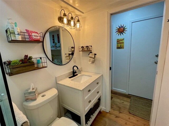 3938 Surfside Blvd Unit 2225, Corpus Christi, TX 78402 - bathroom with wood finished floors, vanity, toilet, and a chandelier