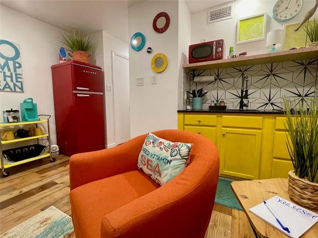 3938 Surfside Blvd Unit 2225, Corpus Christi, TX 78402 - living area featuring light wood-style flooring and bar with sink