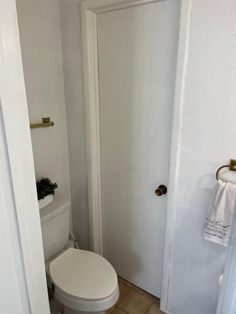 bathroom with tile patterned floors and toilet