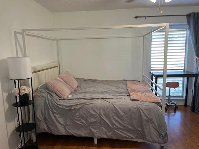 bedroom featuring ceiling fan and dark wood-type flooring