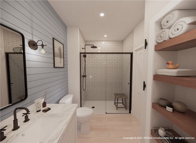 bathroom with vanity, hardwood / wood-style flooring, toilet, and a shower with shower door