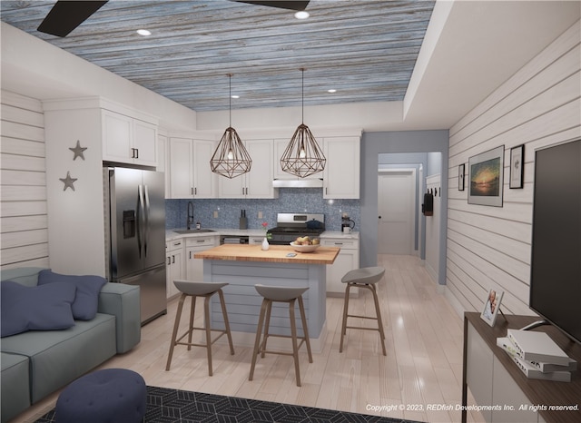 kitchen with stainless steel appliances, white cabinetry, sink, a breakfast bar area, and hanging light fixtures