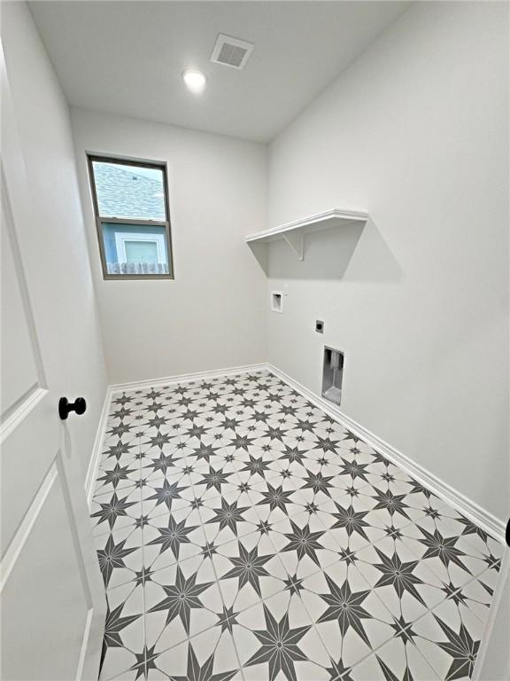 9505 Spanish Oak Dr, Corpus Christi, TX 78410 - laundry area featuring tile patterned floors, electric dryer hookup, and baseboards