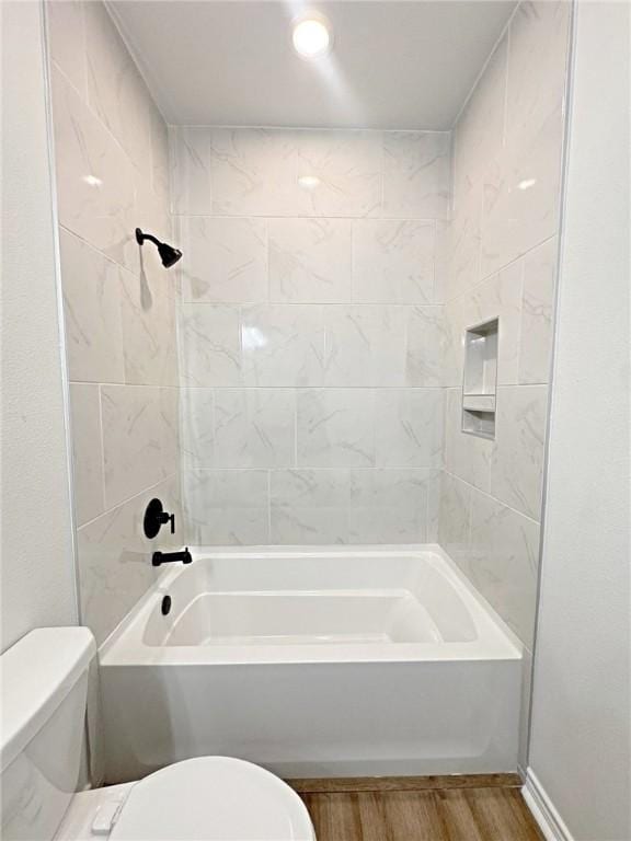 9505 Spanish Oak Dr, Corpus Christi, TX 78410 - bathroom featuring toilet, wood finished floors, and shower / washtub combination