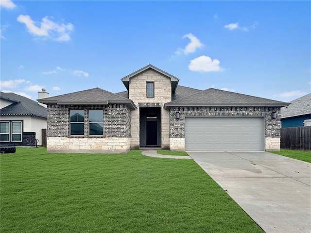 view of front of home featuring a garage and a front lawn