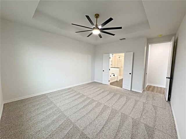 9505 Spanish Oak Dr, Corpus Christi, TX 78410 - unfurnished bedroom featuring carpet flooring, baseboards, and a tray ceiling