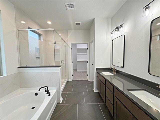 9505 Spanish Oak Dr, Corpus Christi, TX 78410 - bathroom featuring a stall shower, a garden tub, double vanity, a spacious closet, and tile patterned flooring