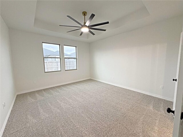 9505 Spanish Oak Dr, Corpus Christi, TX 78410 - carpeted spare room featuring ceiling fan, a raised ceiling, and baseboards