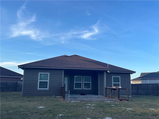 rear view of house featuring a yard, a patio area, and a fenced backyard