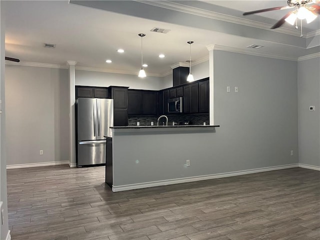 kitchen with dark wood-style floors, stainless steel appliances, dark countertops, and a ceiling fan