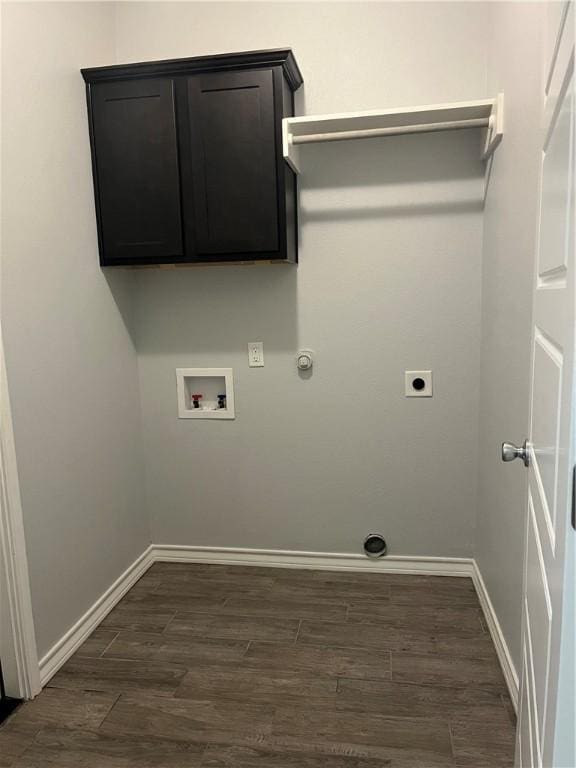 clothes washing area featuring dark wood finished floors, hookup for a washing machine, electric dryer hookup, and baseboards