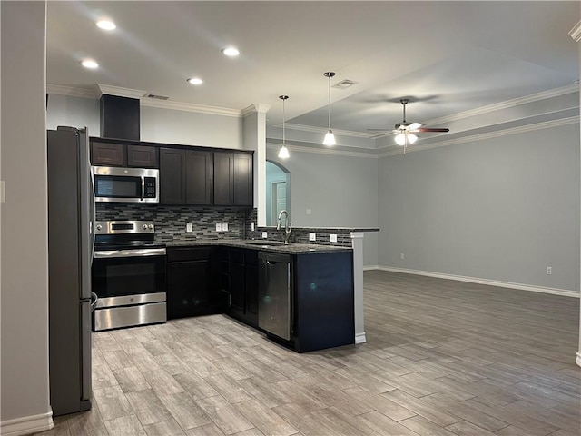 kitchen featuring stainless steel appliances, visible vents, a peninsula, and tasteful backsplash