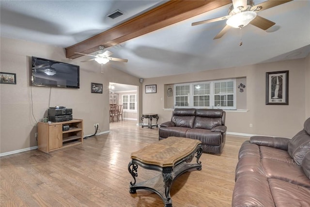 living room with light hardwood / wood-style floors, ceiling fan, and lofted ceiling with beams