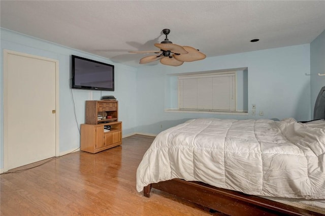 bedroom featuring ceiling fan and light hardwood / wood-style flooring