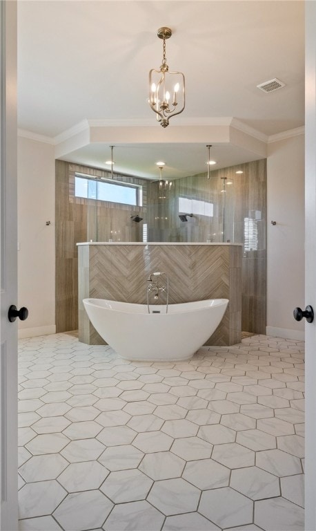 bathroom with visible vents, an inviting chandelier, a freestanding bath, ornamental molding, and a walk in shower