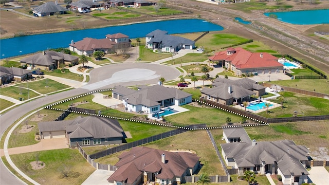 birds eye view of property with a residential view and a water view