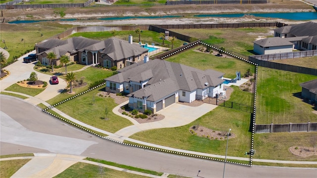 birds eye view of property featuring a residential view and a water view