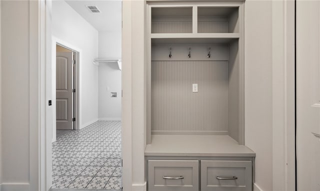 mudroom featuring visible vents, baseboards, and light floors