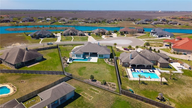 drone / aerial view with a residential view and a water view