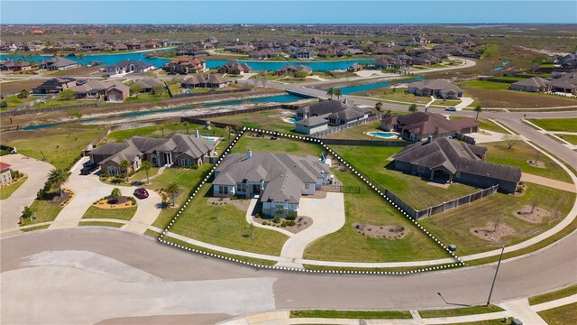 drone / aerial view featuring a water view and a residential view