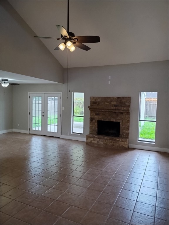 unfurnished living room with high vaulted ceiling, plenty of natural light, and ceiling fan