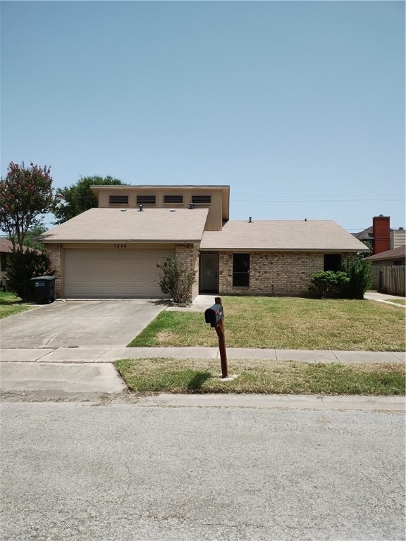 view of front of home featuring a garage and a front lawn