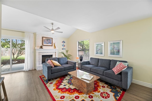 living room with a wealth of natural light, wood-type flooring, ceiling fan, and vaulted ceiling