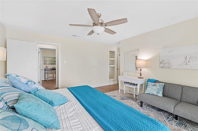 bedroom with ceiling fan and wood-type flooring