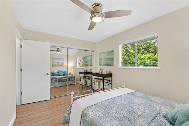 bedroom featuring ceiling fan, wood-type flooring, and a closet