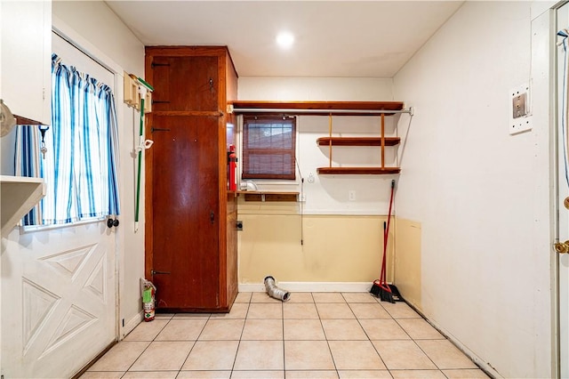 5905 Norvel Dr, Corpus Christi, TX 78412 - laundry room with baseboards and light tile patterned flooring
