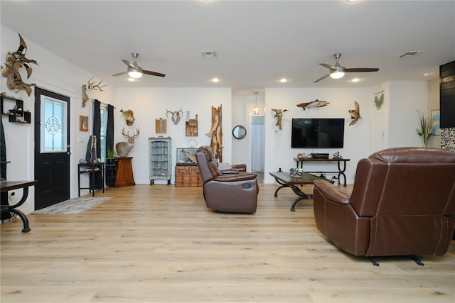 living room with light wood-type flooring and ceiling fan