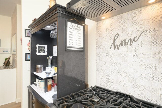 kitchen featuring hardwood / wood-style floors and custom range hood