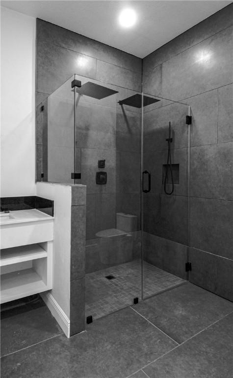 607 Matlock, Aransas Pass, TX 78336 - bathroom with tiled shower, tile patterned flooring, and vanity