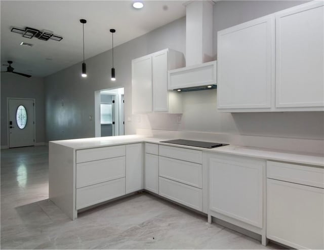 607 Matlock, Aransas Pass, TX 78336 - kitchen featuring black electric cooktop, wall chimney range hood, light countertops, a peninsula, and pendant lighting