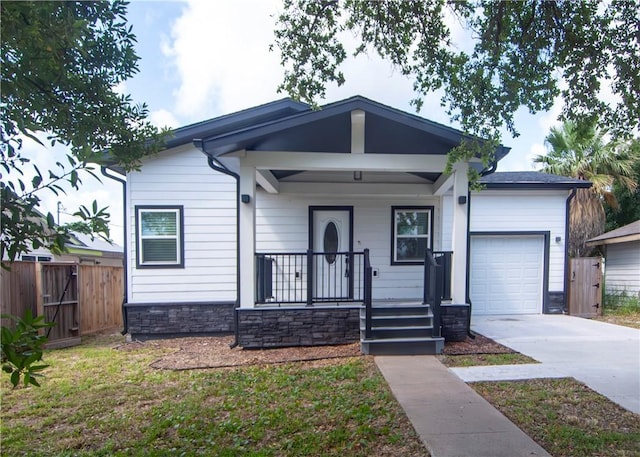 607 Matlock, Aransas Pass, TX 78336 - view of front facade featuring a porch, an attached garage, driveway, and stone siding