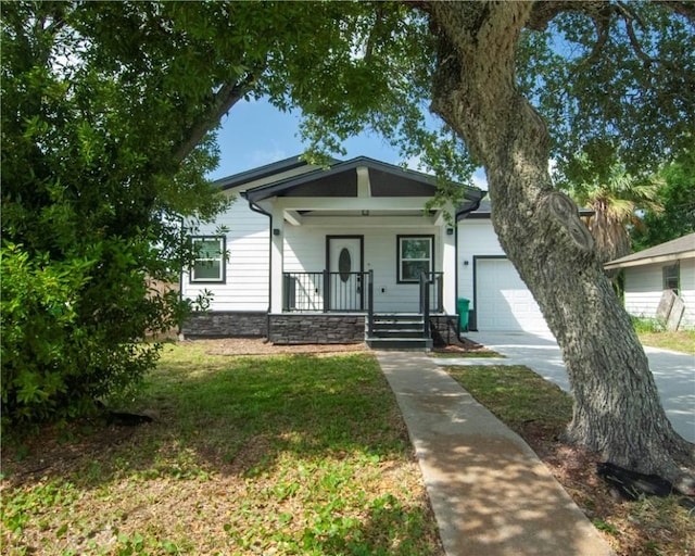 607 Matlock, Aransas Pass, TX 78336 - view of front of home featuring a garage, covered porch, and driveway
