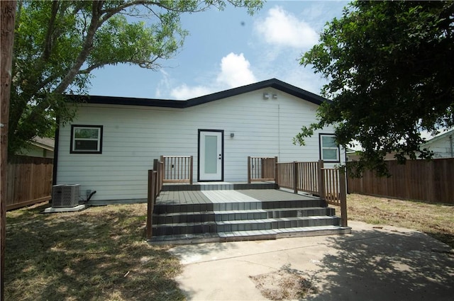 607 Matlock, Aransas Pass, TX 78336 - rear view of property with a fenced backyard, cooling unit, and a wooden deck